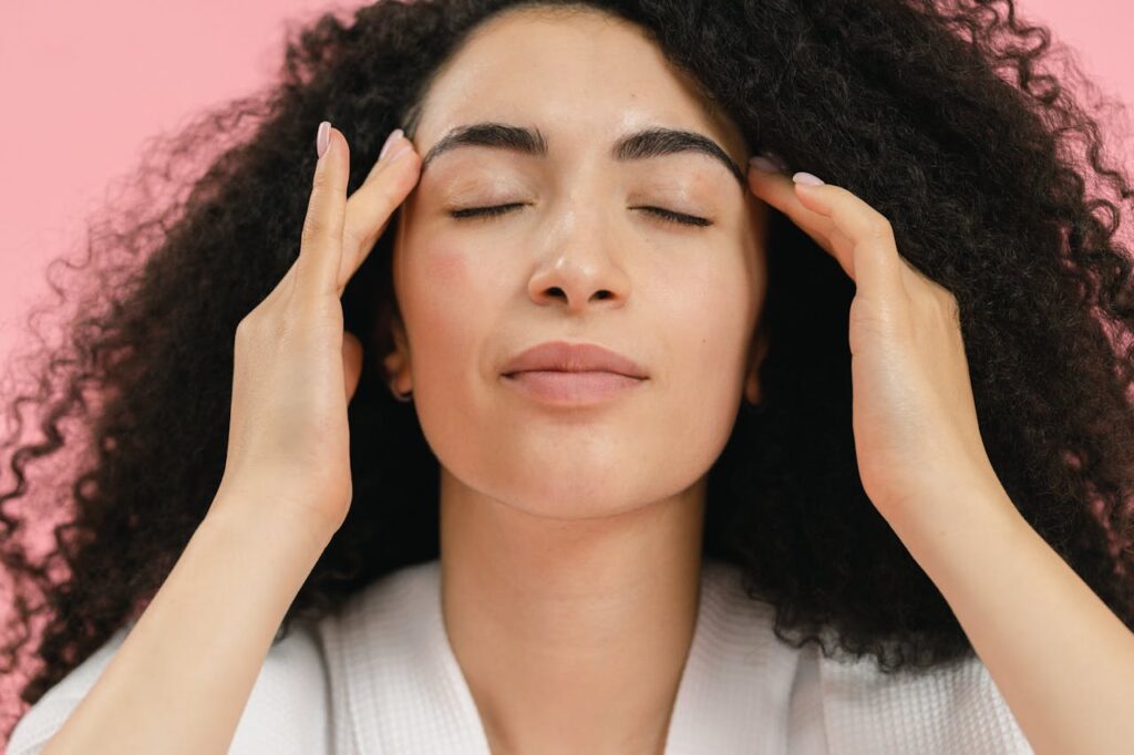 woman touching her face and smiling, clear skin, laser skin resurfacing before and after