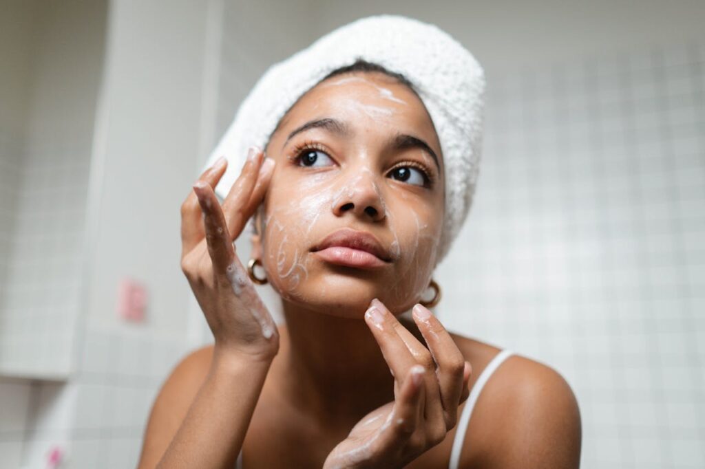 young woman washing her face, chemical peel aftercare