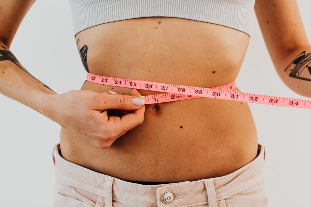 woman measuring waist line, fat dissolving injections